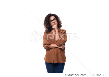 young european curly woman with black hair dressed in a blouse freestanding on a white background 108702119