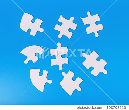 Scattered puzzle pieces in chaos. Jigsaw challenge Scattered puzzle pieces in chaos. Jigsaw challenge 108702310