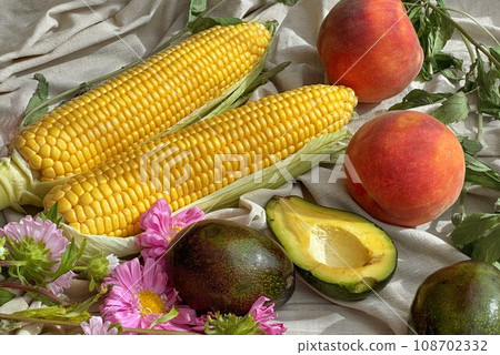 Vegetables and fruits composition with yellow corn maize, peaches, avocado, flowers Vegetables and fruits composition with yellow corn maize, peaches, avocado, flowers 108702332