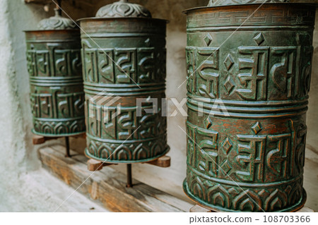 Buddhist prayer bronze drum close-up. Om padme hum. Asian symbol, religion. 108703366
