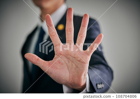 A male lawyer who holds his palm forward A male lawyer who holds his palm forward 108704806