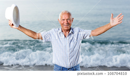 Ordinary satisfied mature man posing near ocean Ordinary satisfied mature man posing near ocean 108704810