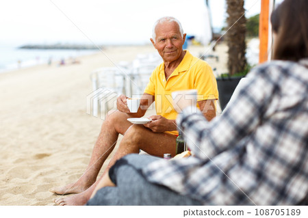 Smiling mature man talking with woman Smiling mature man talking with woman 108705189