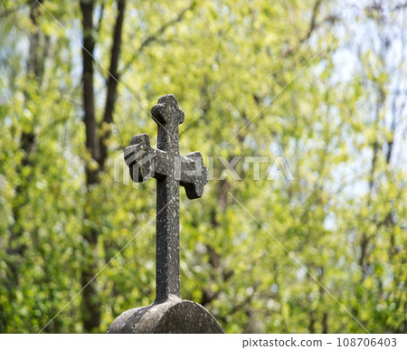 Stone cross on the grave Stone cross on the grave 108706403