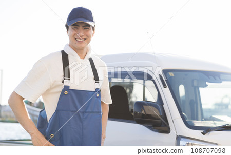 A young fisherman working at a fishing port 108707098