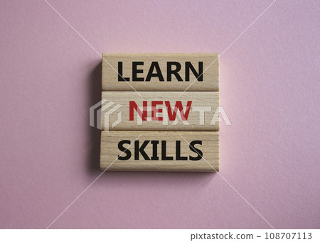 Learn new skills symbol. Concept words Learn new skills on wooden blocks. Beautiful pink background. Business and Learn new skills concept. Copy space. 108707113