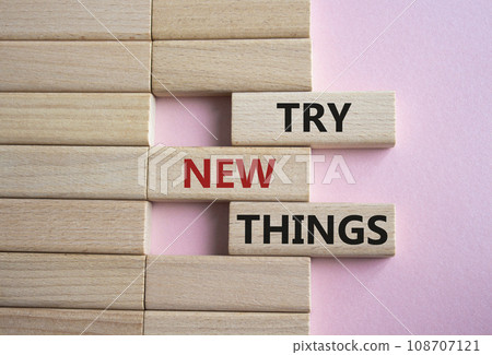Try new Things symbol. Concept words Try new Things on wooden blocks. Beautiful pink background. Business and Try new Things concept. Copy space. 108707121