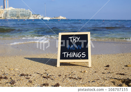 Try new Things symbol. Concept words Try new Things on black chalk blackboard blocks. Beautiful sea green background. Business and Try new Things concept. Copy space. 108707155