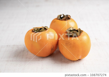 White background and three persimmons 108707274