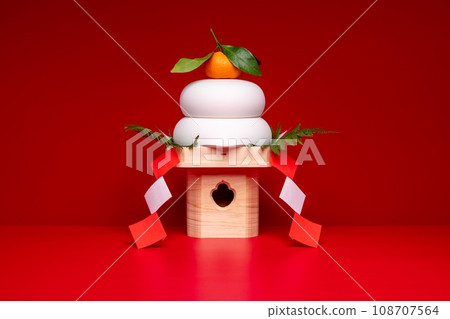 Photo with “Kagami-mochi” placed in the center, red background, with Sanpo (pedestal) 108707564