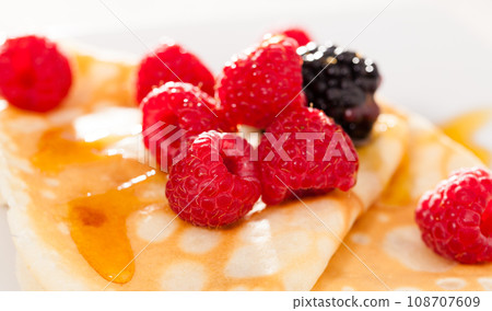 Pancakes with raspberries, blackberries and honey Pancakes with raspberries, blackberries and honey 108707609