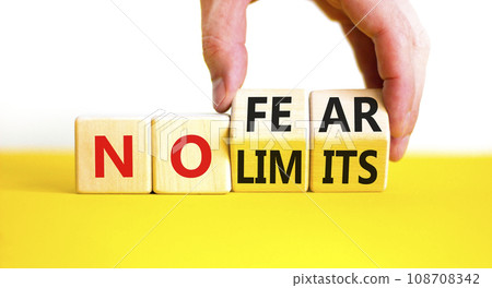 No fear and limits symbol. Concept words No fear No limits on wooden block. Beautiful yellow table white background. Businessman hand. Business motivational no fear and limits concept. Copy space. No fear and limits symbol. Concept words No fear No limits on wooden block. Beautiful yellow table white background. Businessman hand. Business motivational no fear and limits concept. Copy space. 108708342