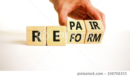Reform and repair symbol. Concept words Reform Repair on wooden block. Beautiful white table white background. Businessman hand. Business reform and repair concept. Copy space. Reform and repair symbol. Concept words Reform Repair on wooden block. Beautiful white table white background. Businessman hand. Business reform and repair concept. Copy space. 108708355