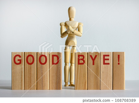 Wooden blocks with words 'good bye'. Wooden model of human. 108708389