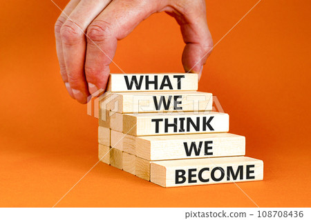 We become or think symbol. Concept word What we think We become on wooden block. Beautiful orange table orange background. Businessman hand. Business we become or think concept. Copy space. 108708436