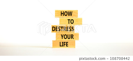 Destress your life symbol. Concept words How to destress your life on wooden blocks. Beautiful white table white background. Copy space. Psychological business destress your life concept. Copy space. 108708442
