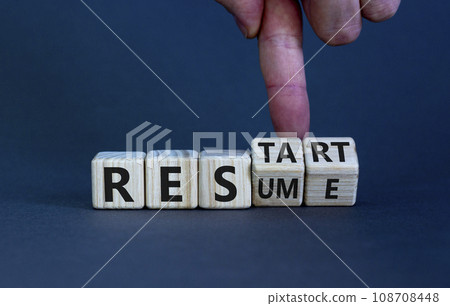 Resume and restart symbol. Businessman hand turns cubes and changes the word 'resume' to 'restart'. Beautiful grey background. Business and resume - restart concept. Copy space. 108708448