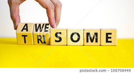 Awesome or trisome symbol. Doctor turns wooden cubes and changes the concept word awesome to trisome. Beautiful yellow table, white background, copy space. Medical, awesome or trisome concept. Awesome or trisome symbol. Doctor turns wooden cubes and changes the concept word awesome to trisome. Beautiful yellow table, white background, copy space. Medical, awesome or trisome concept. 108708449