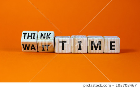 Think or wait time symbol. Turned wooden cubes and changed words 'wait time' to 'think time'. Beautiful orange background, copy space. Business and think or wait time concept. 108708467