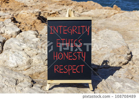 Integrity ethics honesty respect symbol. Concept word Integrity Ethics Honesty Respect on beautiful blackboard. Beautiful stone blue sea background. Business integrity ethics honesty respect concept. Integrity ethics honesty respect symbol. Concept word Integrity Ethics Honesty Respect on beautiful blackboard. Beautiful stone blue sea background. Business integrity ethics honesty respect concept. 108708489