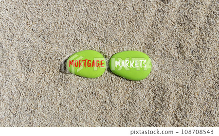 Mortgage markets symbol. Concept words Mortgage markets on beautiful green stone. Beautiful sand beach background. Business mortgage markets concept. Copy space. Mortgage markets symbol. Concept words Mortgage markets on beautiful green stone. Beautiful sand beach background. Business mortgage markets concept. Copy space. 108708543