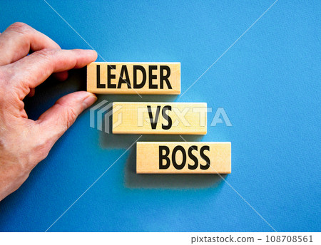 Boss vs leader symbol. Concept words Boss vs versus leader on wooden block. Beautiful blue table blue background. Businessman hand. Business motivational boss vs leader concept. Copy space. 108708561