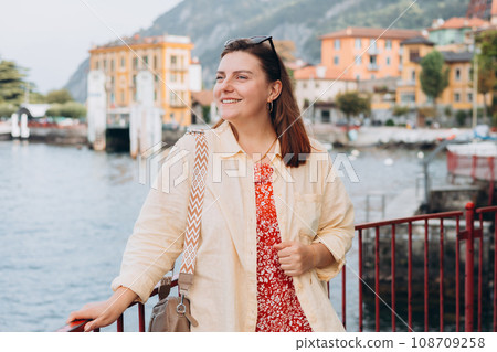 Happy brunette 30s woman enjoying summer holidays. Concept of vacation and travelling. Varenna, Italy. Lake Como 108709258