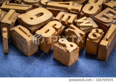 random letterpress wood type printing blocks against handmade textured paper random letterpress wood type printing blocks against handmade textured paper 108709505