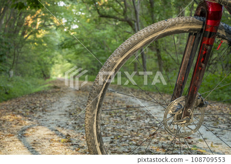 dusty front wheel of a gravel touring bike on the Katy Trail near McKittrick, Missouri, in early fall scenery dusty front wheel of a gravel touring bike on the Katy Trail near McKittrick, Missouri, in early fall scenery 108709553