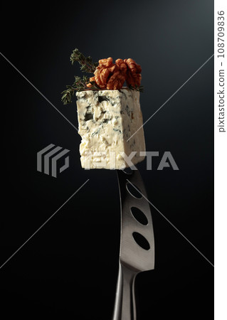 Blue cheese on a knife. 108709836