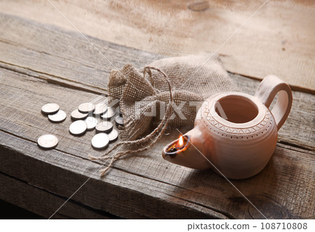 Pouch with silver coins on a wooden table Pouch with silver coins on a wooden table 108710808