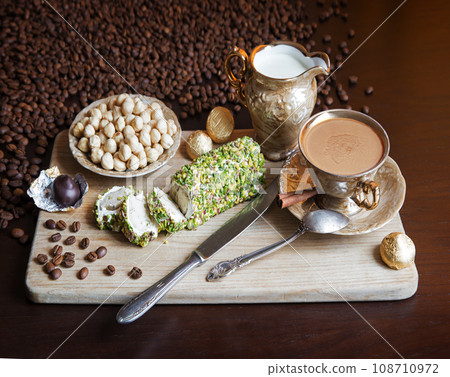 Sweets on the background of coffee on the table Sweets on the background of coffee on the table 108710972