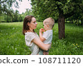 Young woman mom and son play in nature, spend time together and have fun 108711120