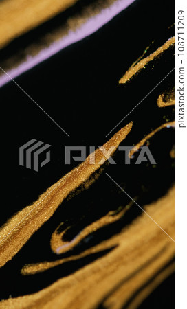 Glitter paint spill fluid background golden black 108711209