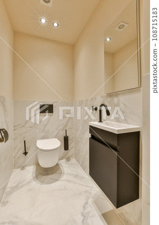 a modern bathroom with marble flooring and white walls, along with a black vanity in the room is illuminated by recessed lights a modern bathroom with marble flooring and white walls, along with a black vanity in the room is illuminated by recessed lights 108715183