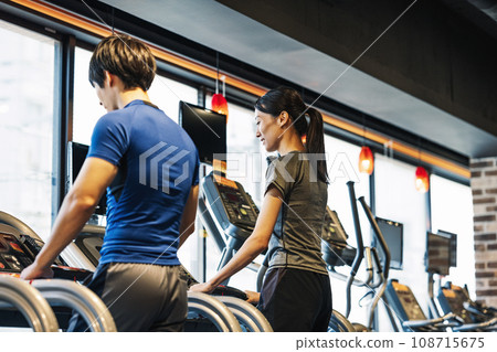 Men and women walking at the gym Men and women walking at the gym 108715675