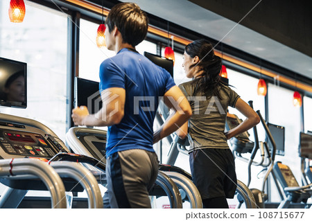 Men and women running at the gym Men and women running at the gym 108715677
