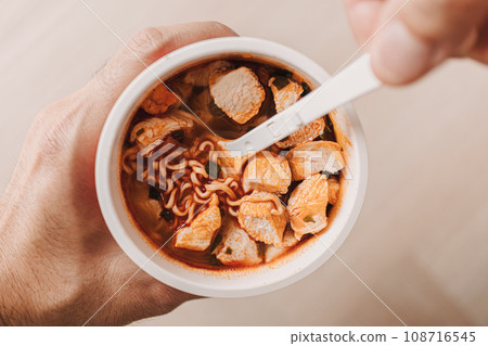 Top view of spicy instant noodle cup with chicken meat. 108716545
