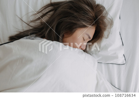 Happy woman still sleeping peacefully in the morning. Happy woman still sleeping peacefully in the morning. 108716634