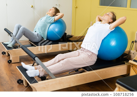Teenagers training pilates in gym 108718256