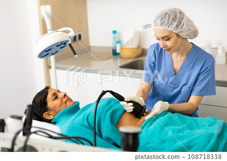 Woman cosmetologist making ultrasound lifting procedure 108718338