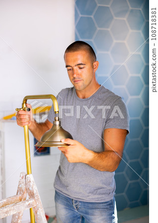 Man assembling shower in bathroom of new apartment 108718381