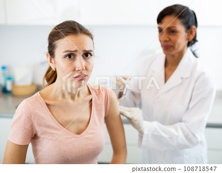 Woman client of medical clinic afraid of syringe 108718547