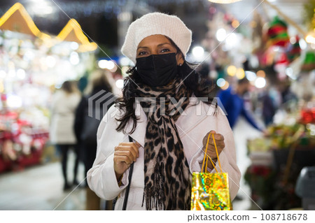 Portrait of a Latin American woman in a mask who came to a Christmas fair 108718678