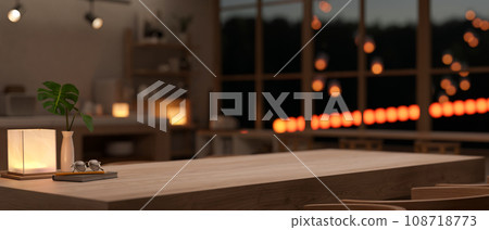 Empty mockup space on a wooden dining table with accessories in a modern dark room at night. 108718773