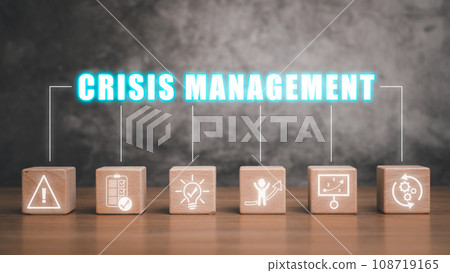 Crisis management concept, Wooden block on desk with crisis management icon on virtual screen. Crisis management concept, Wooden block on desk with crisis management icon on virtual screen. 108719165