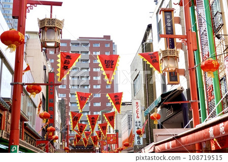 Kobe Nanjing Street during the Chinese New Year Festival. Scenery of Nanjing West Road with bright red pennant flags hanging here and there. Chuo Ward, Kobe City. 108719515