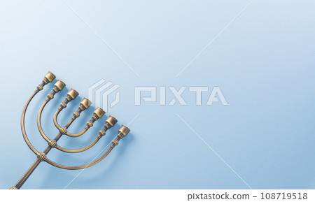 Jewish holiday Hanukkah concept. Top view of goldren menorah on pastel blue background. Jewish holiday Hanukkah concept. Top view of goldren menorah on pastel blue background. 108719518