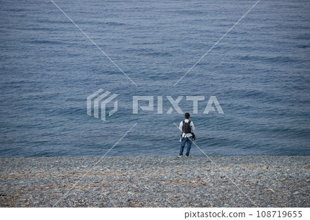A man fishing in the sea on the coast in the morning A man fishing in the sea on the coast in the morning 108719655