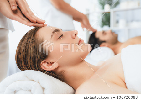 Caucasian couple enjoying relaxing anti-stress head massage. Quiescent Caucasian couple enjoying relaxing anti-stress head massage. Quiescent 108720088
